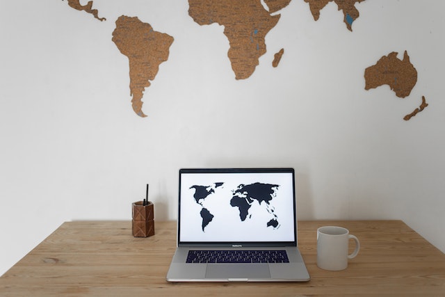 A display of the world map on the wall and PC.