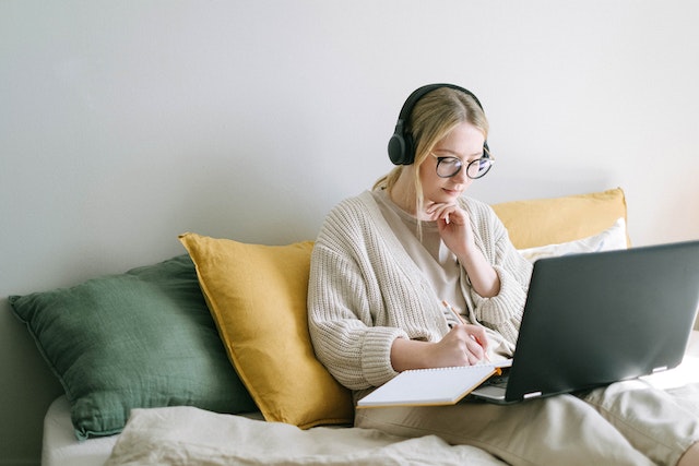 A lady journaling her trips after dropping multiple pins on Google Maps.