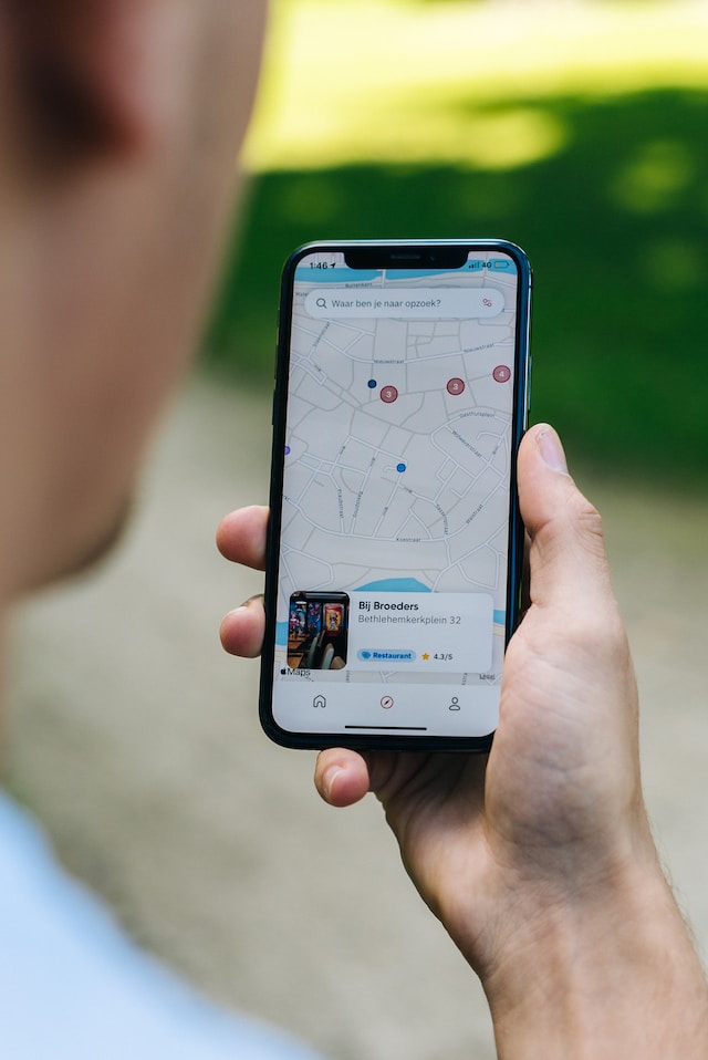 A person using Google Maps for iOS to plan a route using multiple pins.