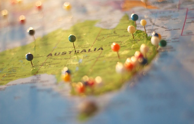 Multiple physical push pins on a map