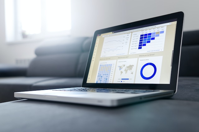 Computer on a sofa showing grid heat maps with statistics.