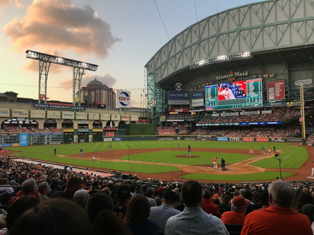 Thousands of baseball enthusiasts are watching a game in Minute Maid Park, Houston, Texas.