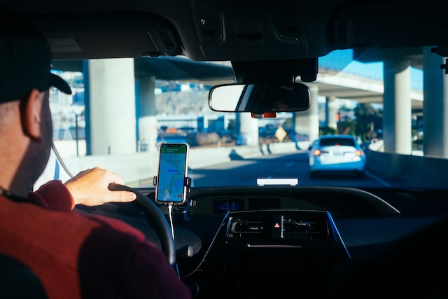 A bus driver using Google Maps’ route planner to deliver products to consumers efficiently.