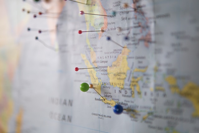 Close-up image of a physical map with pins to map multiple locations.
