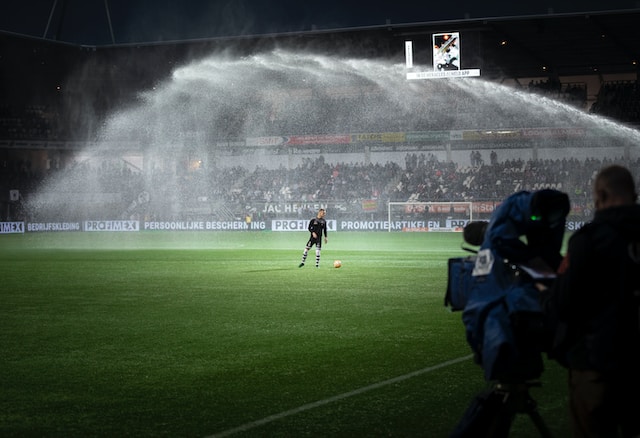 A soccer player alone on the field preparing for a match.