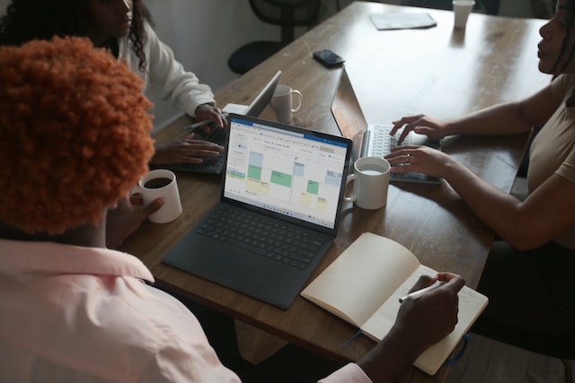 A person uses Microsoft Excel on their laptop to plot various geographic coordinates.
