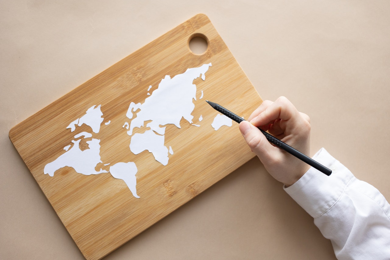 a person holding a pen creating a map