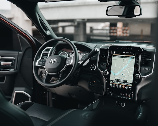 A GPS navigation system in a car showing directions to a destination.