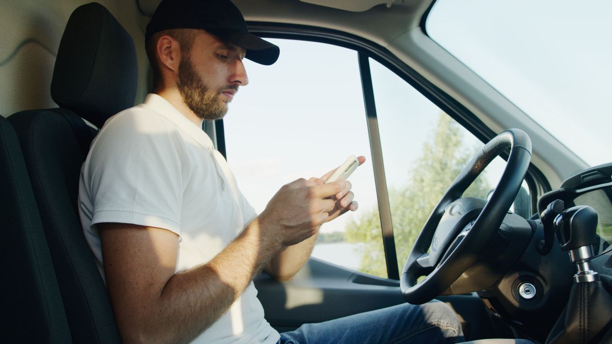 A delivery driver checking travel time on Google Maps before starting his trip.