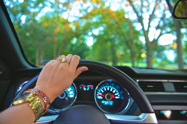 A woman in her car navigating through her driving route.