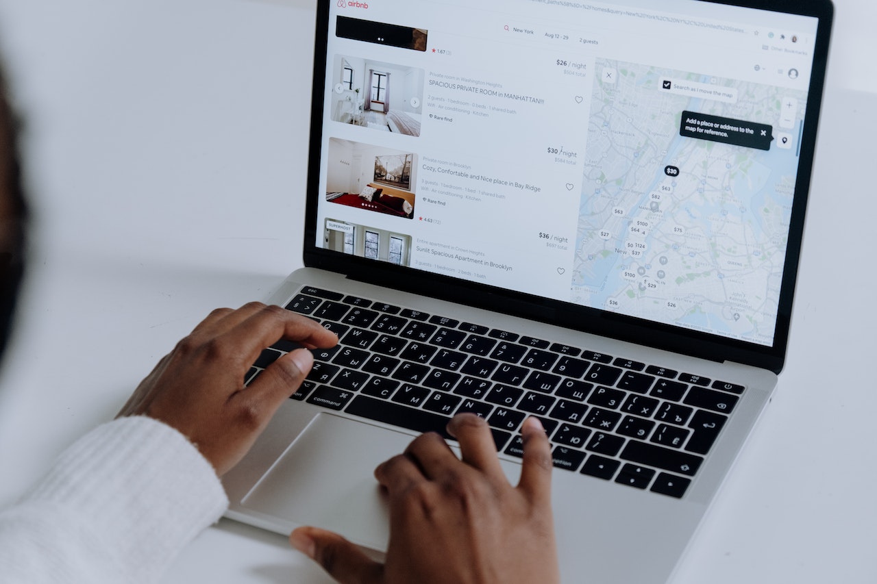 A person viewing a location on a map with their laptop computer.