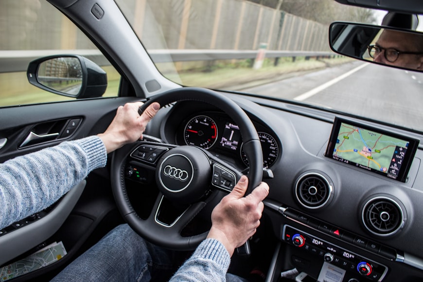 A man using an inbuilt navigation app in his car to get to his destination faster.