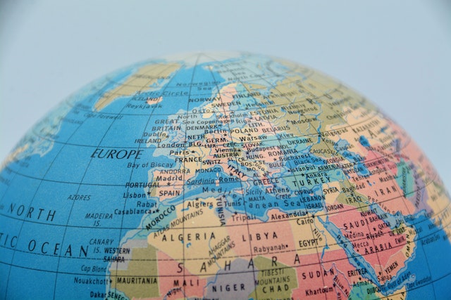 A globe displays lines of longitude and latitude.